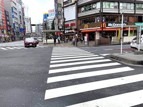 Take the pedestrian crossing directly in front of you.